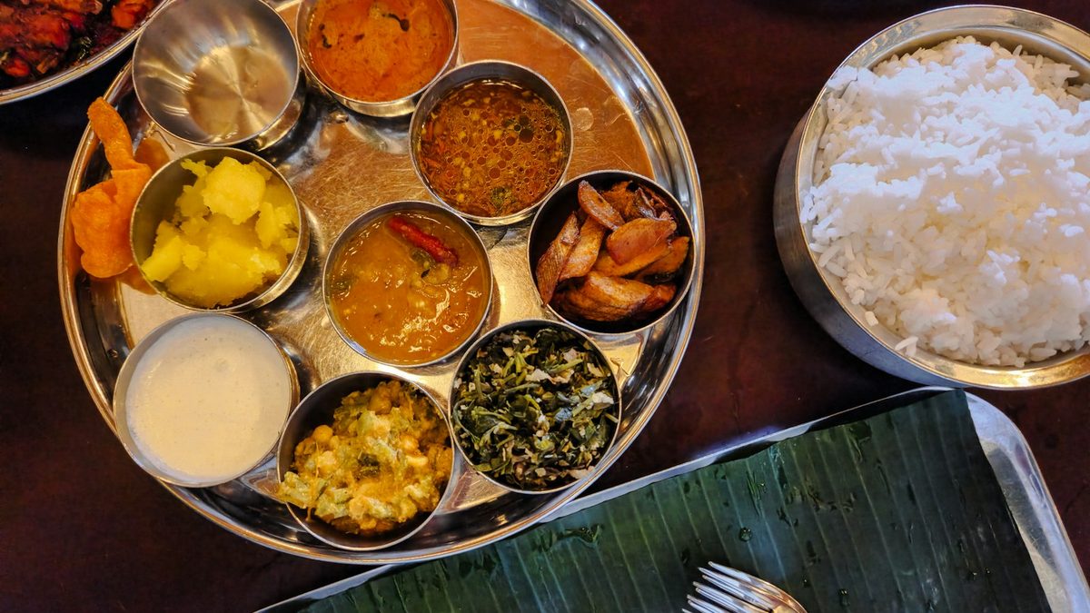 An Indian thali plate served with rice, dal, sabzi and side dishes