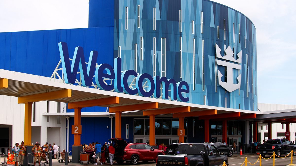 The Royal Caribbean cruise terminal building at the Port of Galveston, Texas, with passengers and vehicles at the entrance